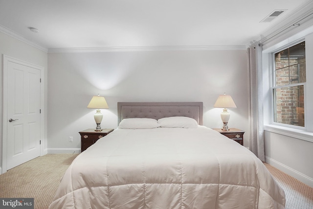 carpeted bedroom featuring visible vents, baseboards, and ornamental molding