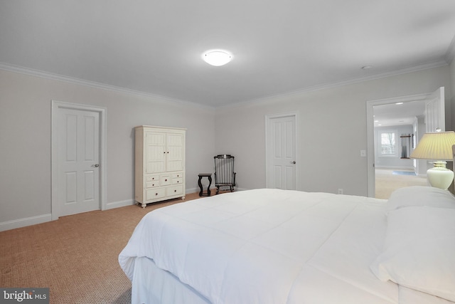 bedroom with crown molding, baseboards, and carpet floors