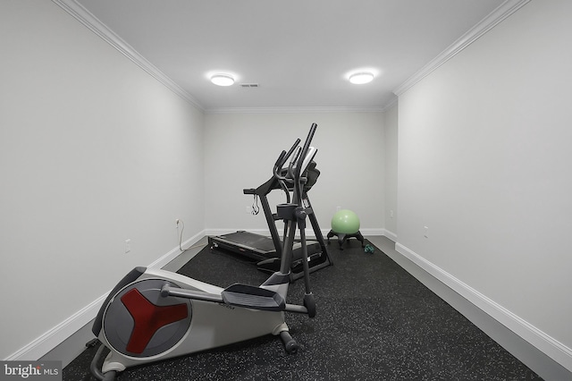 exercise area featuring visible vents, baseboards, and ornamental molding