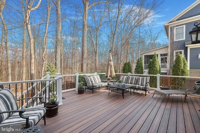 wooden terrace with an outdoor living space