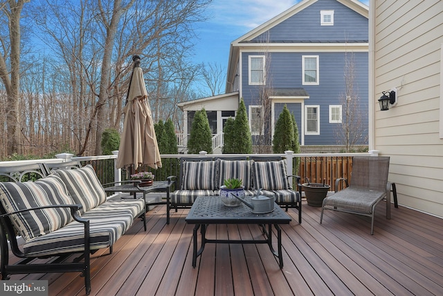 wooden terrace with an outdoor living space