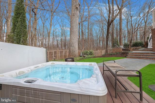 view of pool with a patio area, a covered hot tub, fence, and a yard