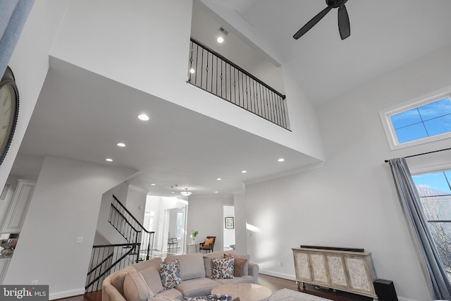 living room with recessed lighting, stairway, a high ceiling, and ceiling fan