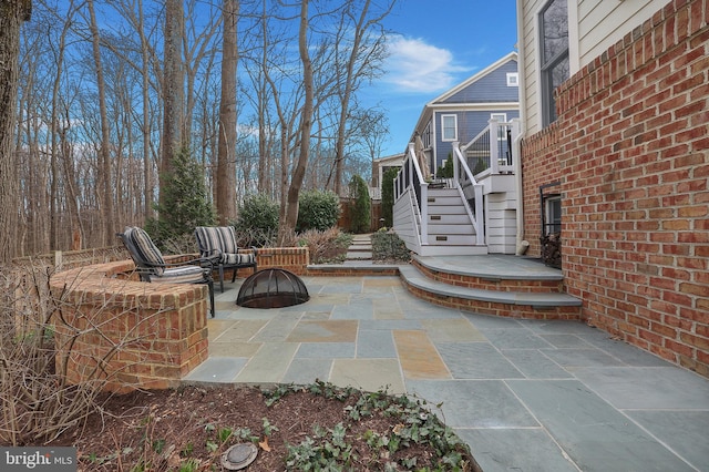 view of patio with a fire pit and stairs