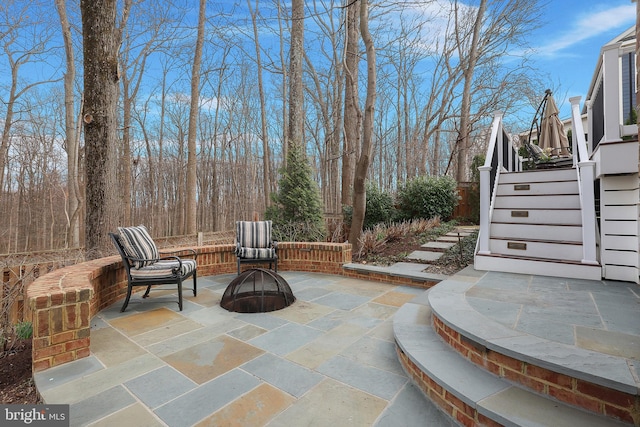 view of patio with an outdoor fire pit and stairs