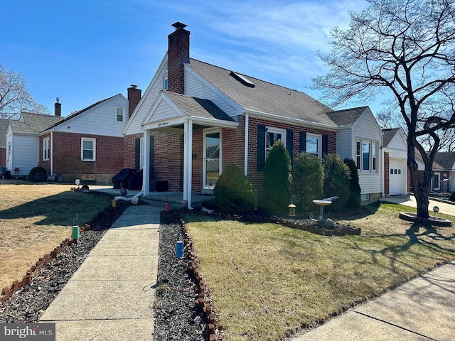 bungalow-style house with a shingled roof, a porch, brick siding, and a front lawn