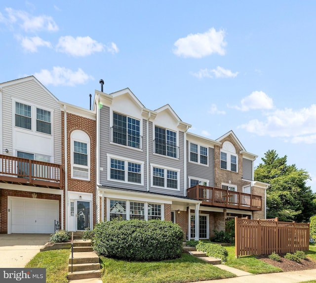 townhome / multi-family property featuring concrete driveway, an attached garage, and brick siding