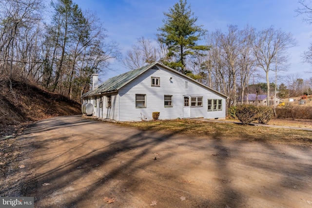 view of property exterior with a chimney