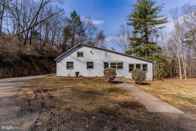 view of side of home with a lawn