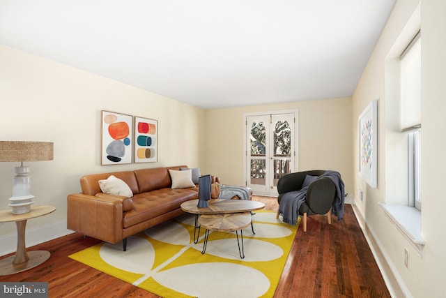 living area with wood finished floors and baseboards