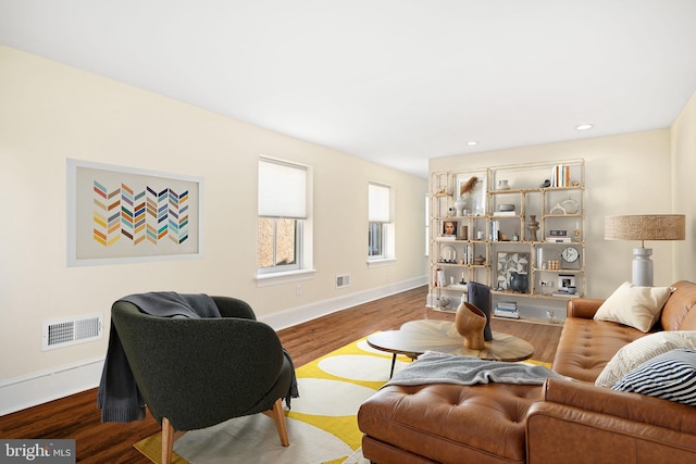 living area featuring visible vents, recessed lighting, baseboards, and wood finished floors