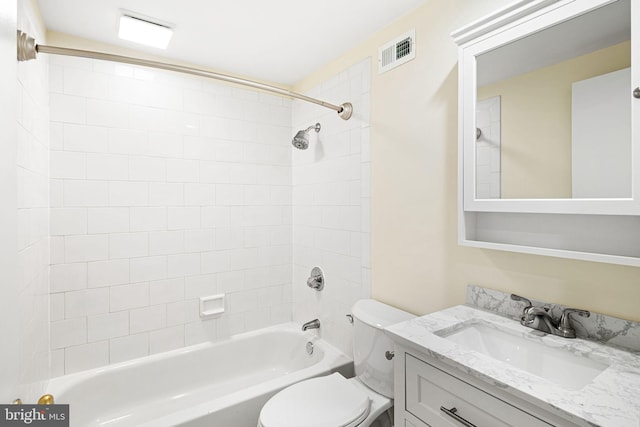 bathroom featuring vanity, toilet, visible vents, and shower / washtub combination