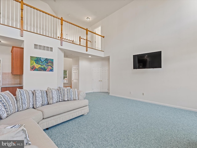 carpeted living room with visible vents and baseboards