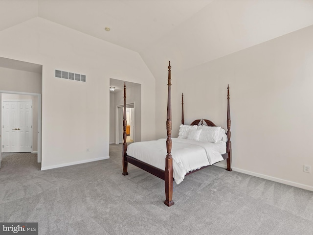 bedroom with visible vents, baseboards, carpet, and lofted ceiling