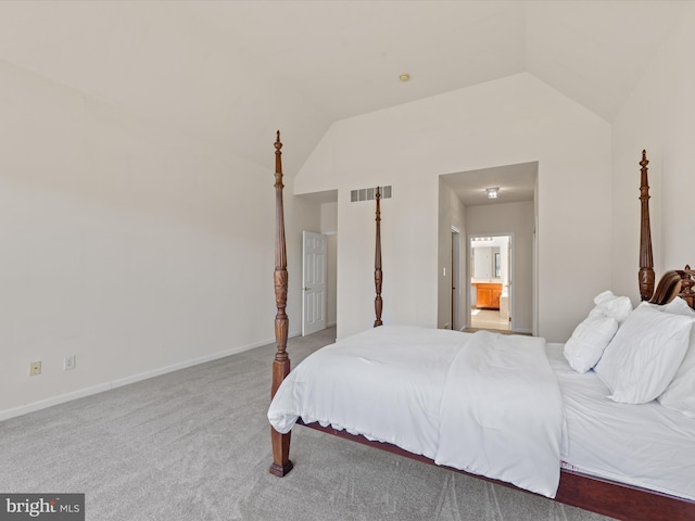 carpeted bedroom with visible vents, lofted ceiling, baseboards, and connected bathroom