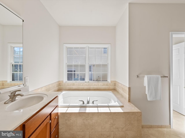 bathroom featuring tile patterned floors, a garden tub, and vanity