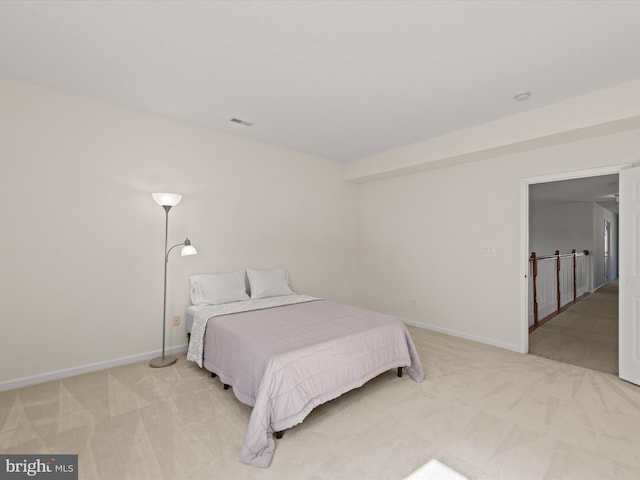 carpeted bedroom featuring visible vents and baseboards