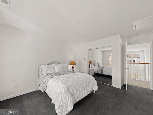 bedroom with baseboards, visible vents, attic access, a closet, and dark colored carpet