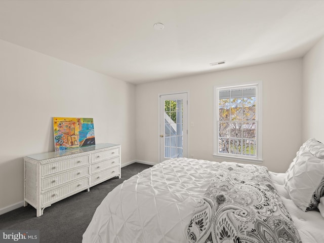 bedroom with access to exterior, visible vents, dark carpet, and baseboards