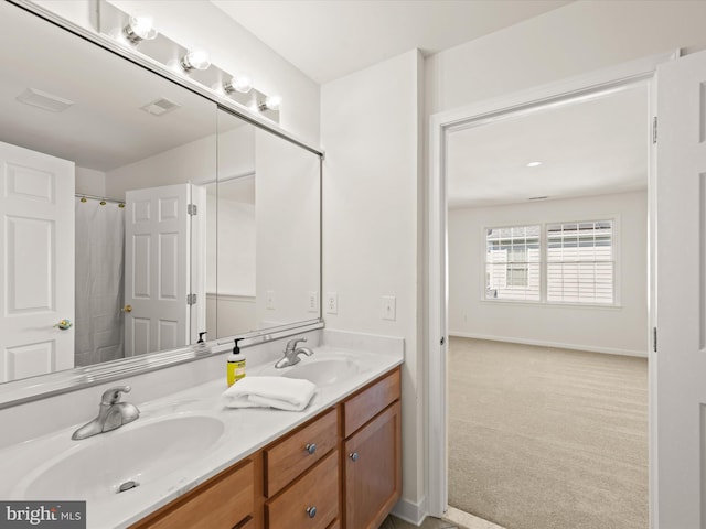 bathroom with a sink, visible vents, baseboards, and double vanity