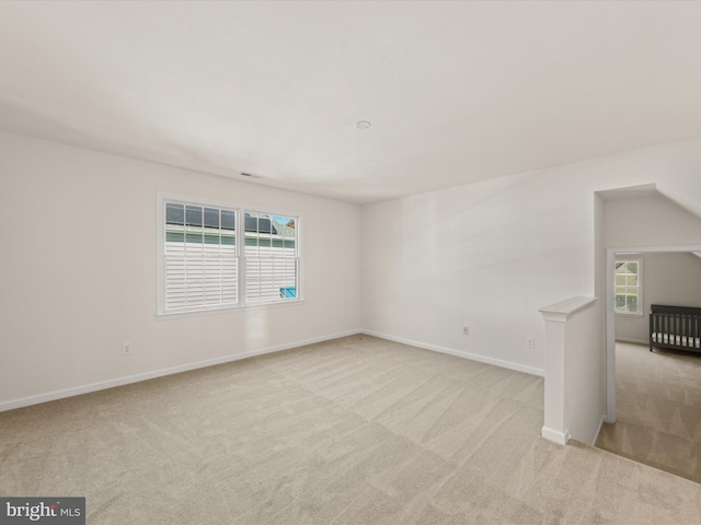 carpeted spare room featuring baseboards