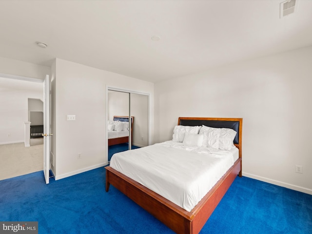 bedroom with a closet, visible vents, baseboards, and carpet