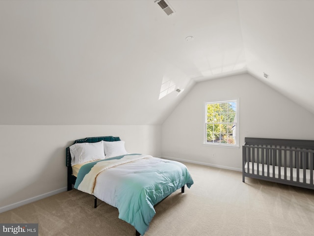 carpeted bedroom featuring visible vents, baseboards, and vaulted ceiling