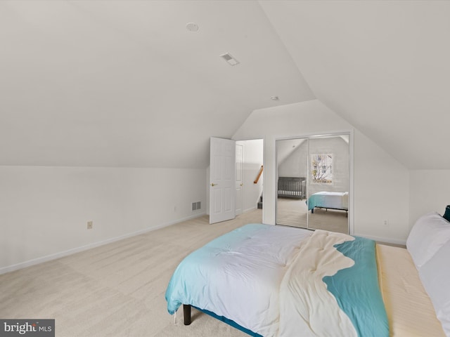 bedroom featuring light carpet, visible vents, baseboards, and vaulted ceiling