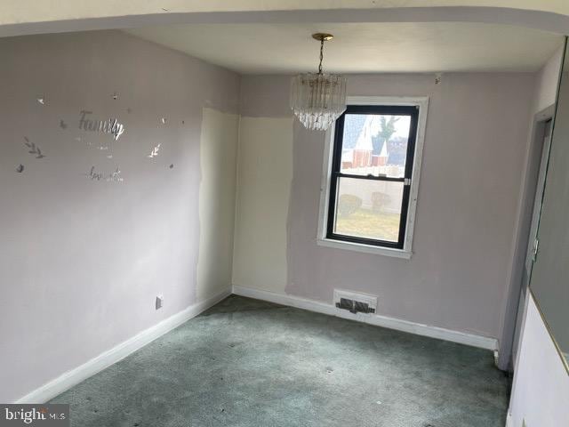 unfurnished dining area with visible vents, carpet floors, baseboards, and a chandelier