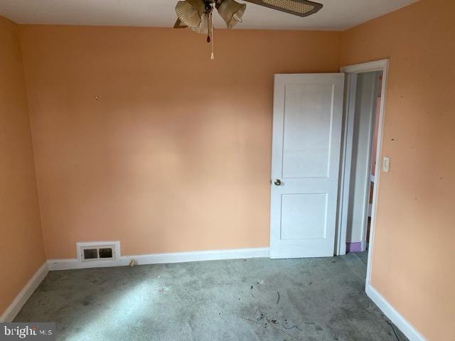 spare room featuring visible vents, ceiling fan, and baseboards