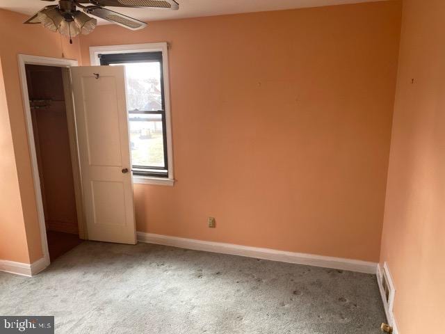 unfurnished bedroom with visible vents, carpet flooring, and baseboards