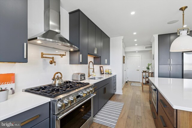 191 Presidential Blvd Unit R1018-1019, Bala Cynwyd, PA 19004 - kitchen featuring wall chimney range hood, high end stainless steel range oven, light wood-style flooring, light countertops, and recessed lighting