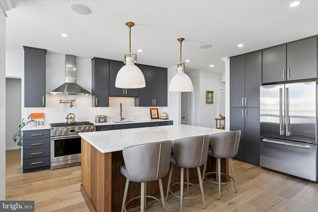191 Presidential Blvd Unit R1018-1019, Bala Cynwyd, PA 19004 - kitchen with high end appliances, wall chimney exhaust hood, light wood finished floors, light countertops, and recessed lighting