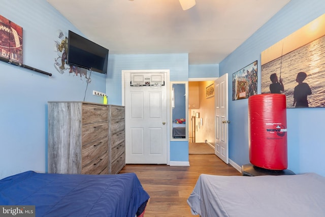 bedroom featuring baseboards and wood finished floors