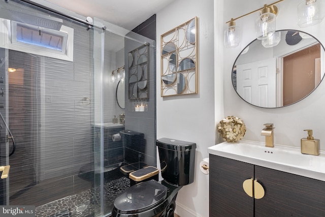 bathroom with vanity, a shower stall, and toilet