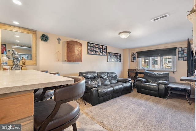 carpeted living room featuring recessed lighting and visible vents