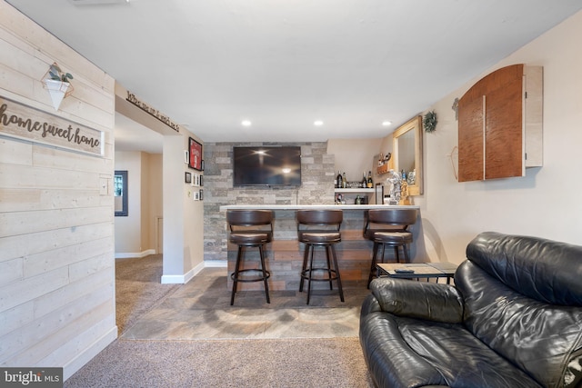 bar featuring recessed lighting, carpet, baseboards, and indoor bar