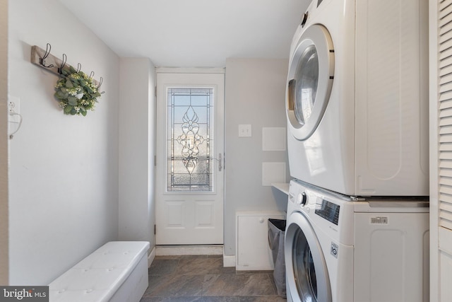 clothes washing area with laundry area and stacked washer / drying machine