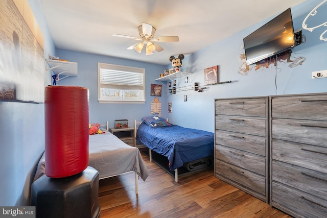 bedroom featuring a ceiling fan and wood finished floors