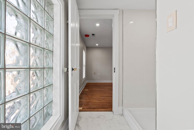 corridor with recessed lighting, baseboards, and marble finish floor