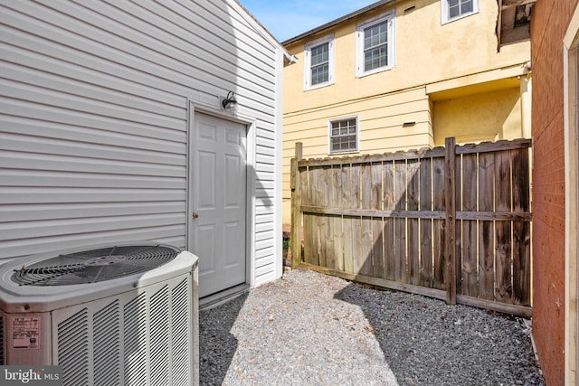 view of patio / terrace with cooling unit and fence