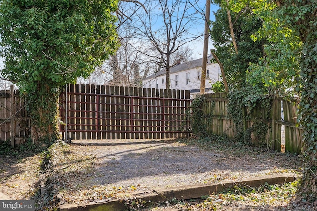 view of gate featuring a fenced backyard