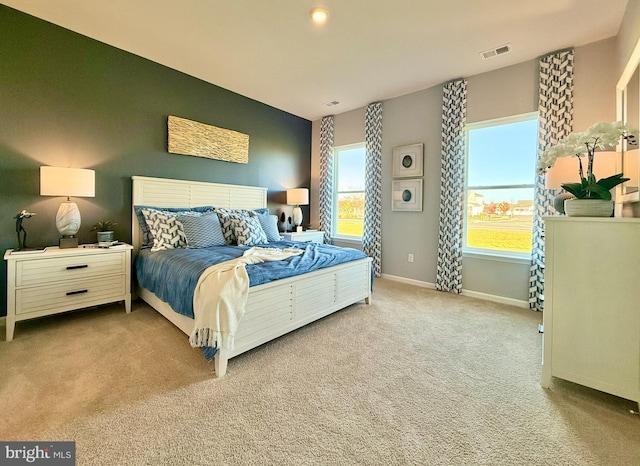 bedroom with baseboards, visible vents, and carpet floors