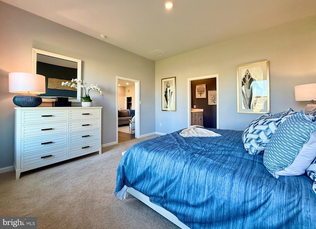 bedroom with ensuite bath, lofted ceiling, baseboards, and carpet floors