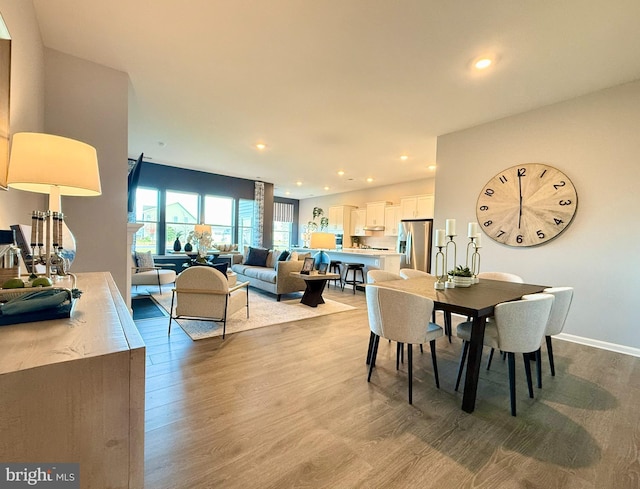 dining room with recessed lighting, baseboards, and wood finished floors