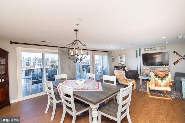 dining space with wood finished floors, visible vents, and a wealth of natural light