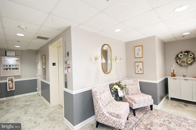 living area with recessed lighting, baseboards, visible vents, and a drop ceiling