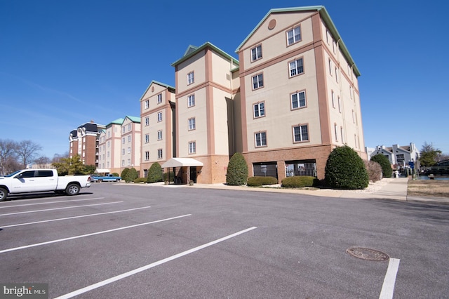 view of building exterior with uncovered parking