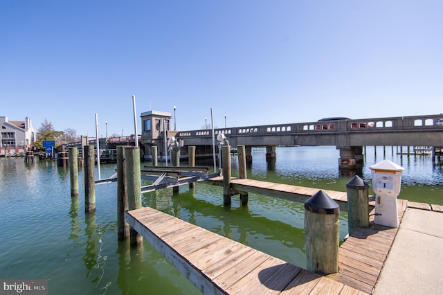 dock area with a water view and boat lift