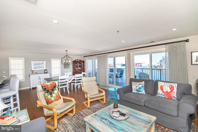 living area featuring recessed lighting, visible vents, an inviting chandelier, and wood finished floors